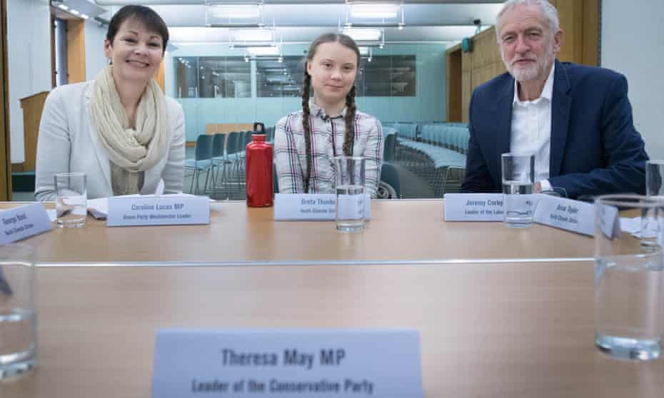 A name plate marks a place for the absent prime minister as Caroline Lucas and Jeremy Corbyn meet Greta Thunberg.