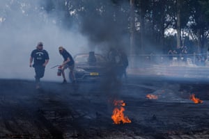 Flaming chunks of tyre litter the skidpan after a burnout ended with a bang.