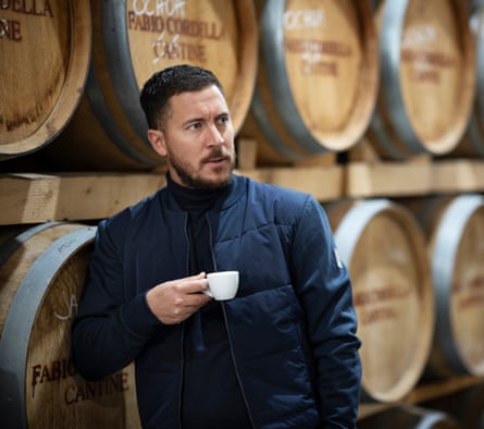 Eden Hazard in front of some barrels of wine dedicated to the Belgian