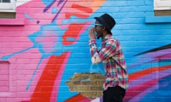 Black man in sunglasses shouting near colorful wall