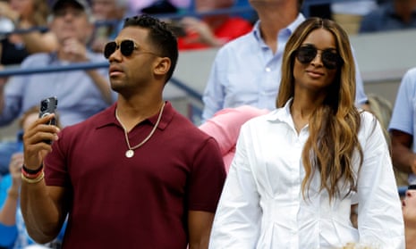 Russell Wilson and Ciara take in the match.