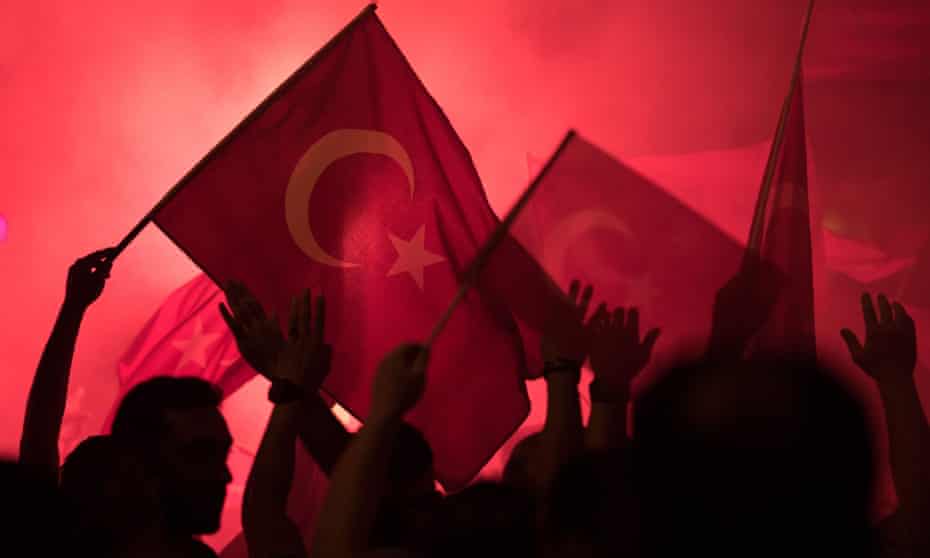 People shout slogans and hold Turkish national flags during a demonstration, against the failed Army coup attempt, at Taksim Sqaure, in Istanbul