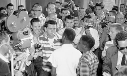 The photo of North Little Rock High that has reemerged recently. A teenaged Jerry Jones is towards the back of the crowd in a horizontal striped shirt, to the right of the raised camera