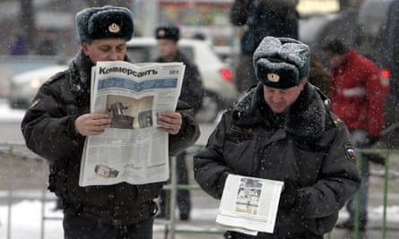 Russian police officers read newspapers on the streets of central Moscow,  2007.