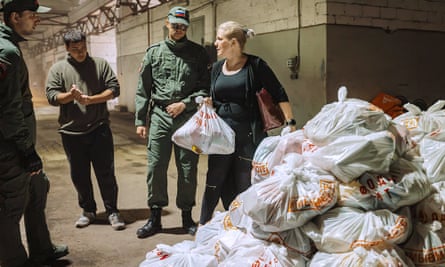 A photo released by Kursk region governor Alexei Smirnov shows volunteers reloading humanitarian aid in a warehouse in Kursk on 9 August.