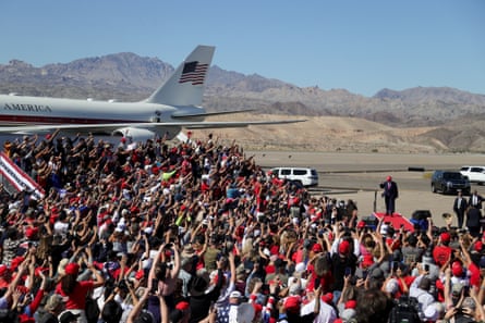 a crowd cheers for Donald Trump