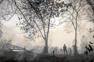Indonesian police spray water on a peatland fire in the region of Kampar.