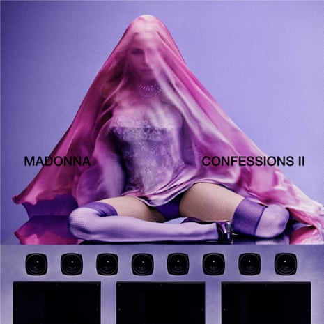 Album cover art shows Madonna doing a cross legged pose with a purple veil over her head