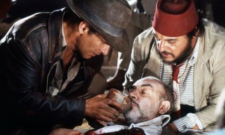 Harrison Ford, left, with John Rhys-Davies, tends to his father, Sean Connery, in Indiana Jones and the Last Crusade.