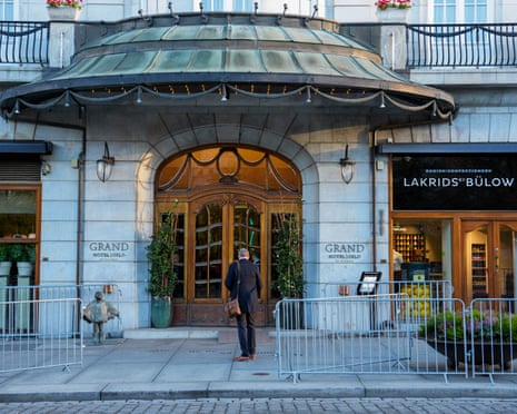 Police barriers line the pavement outside the Grand Hotel Oslo's ornate entrance