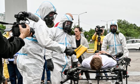 Workers in protective suits and gas masks during staff exercises at the Zaporizhzhia nuclear power plant.