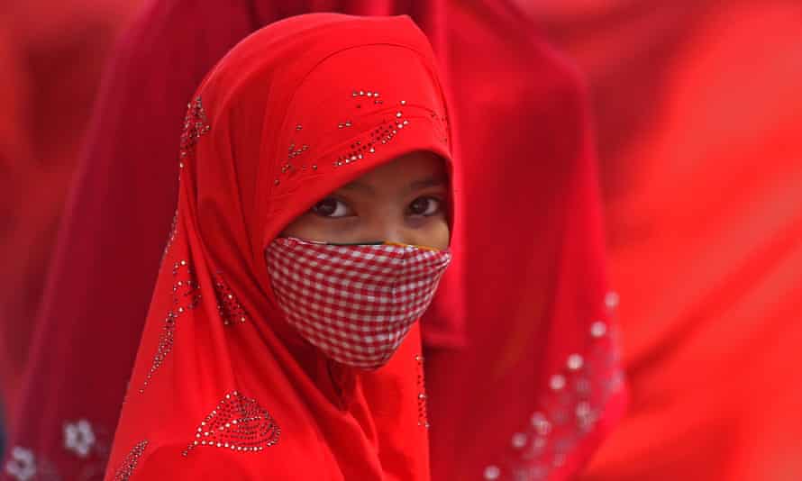 An Indian Muslim girl wears a mask in Bangalore, India 28 January 2022. The Karnataka State Government announced fresh guidelines for Covid testing for symptomatic and asymptomatic people.