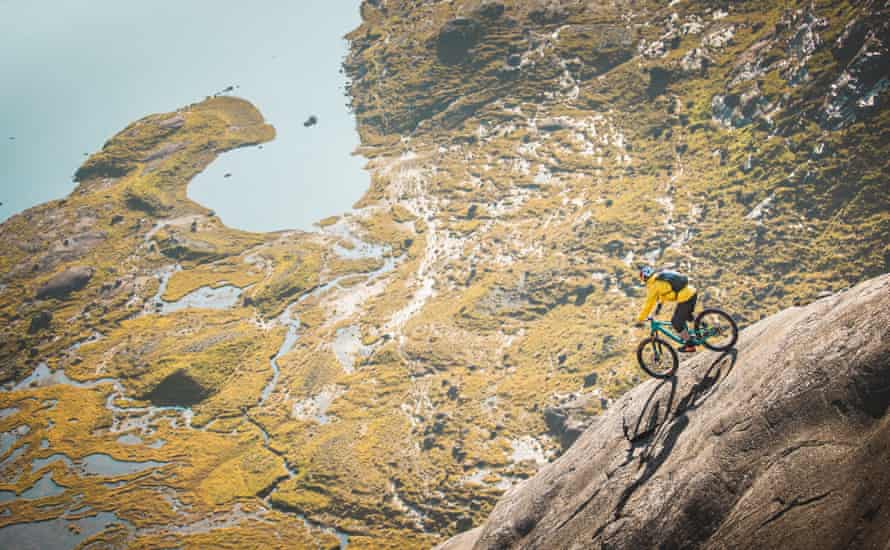 cyclist on steep rock face
