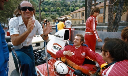 Jochen Mass, centre, in the pits during the Monaco Grand Prix at Monte Carlo in 1975, with a fellow driver, Mike Hailwood, on the left.