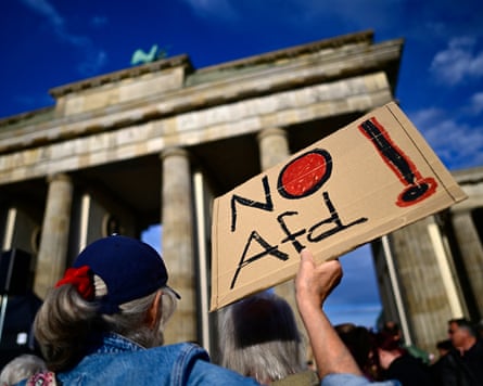 A participant displays a placard with the lettering ‘No AfD’ in front of the Brandenburg Gate in Berlin.