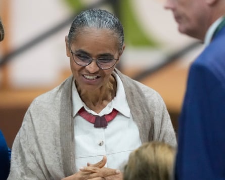 Marina Silva smiles, clasping her hands
