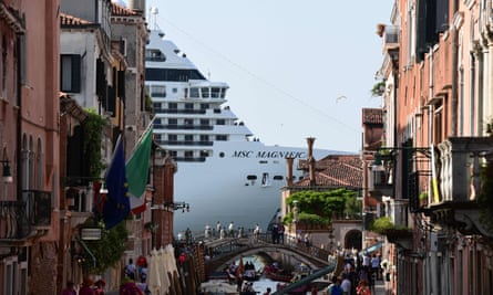 A cruise ship towering over a canal in Venice, June 2019