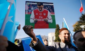 A demonstrator in Istanbul holds up a picture of Arsenal’s Mesut Özil who expressed his horror at China’s treatment of the Uighurs.