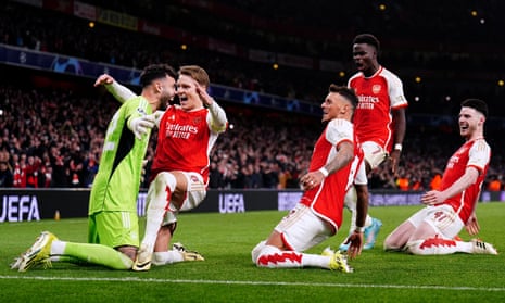 Arsenal players race towards their goalkeeper David Raya after his second shootout save sealed their Champions League progress