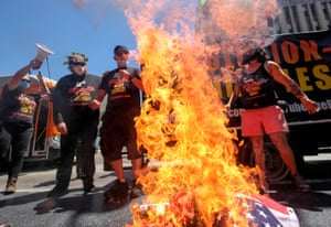 Gregory “Joey” Johnson, whose burning of an American flag in Texas in 1984 led to a U.S. Supreme Court ruling upholding the act as free speech, burns a U.S. flag near Donald Trump’s star on the Hollywood Walk of Fame during an anti-Trump rally