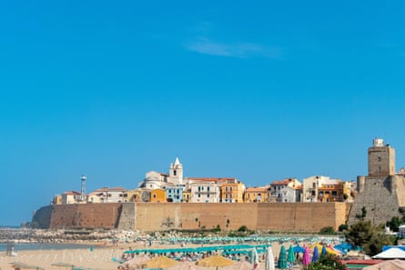 Panoramic view of the old town of Termoli with beach umbrellas, the colorful houses and Svevo Castle, Italy