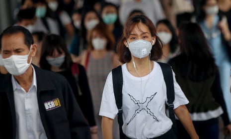 Commuters wearing protective masks in Bangkok, Thailand.