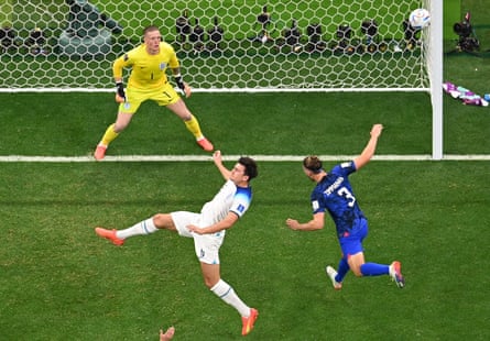 England’s Jordan Pickford looks on as Harry Maguire (left) and USA’s Walker Zimmerman attack the ball.