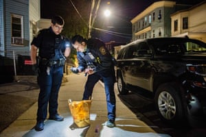 Arteaga (left) and Kyle Meehan inspect drug paraphernalia at a crime scene