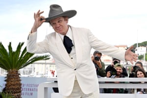 John C. Reilly strikes a pose as photographers take his picture