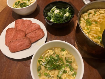 Egg-drop pasta soup in bowls, with a plate of fried Spam slices on the side.