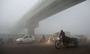 An Indian rickshaw puller passes under a bridge in Delhi, where air quality is ranked ‘very poor’.