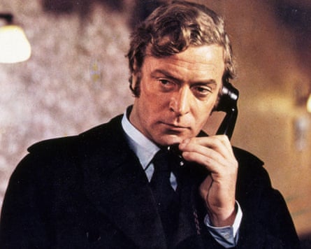 Man in a black suit on the phone