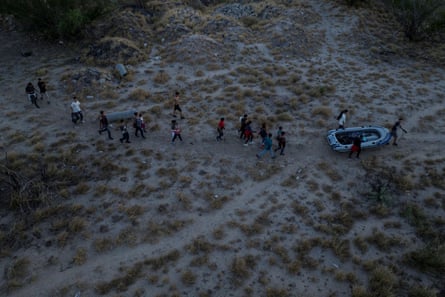 Migrants help carry a raft toward the bank of the Rio Bravo del Norte, also known as the Rio Grande river.
