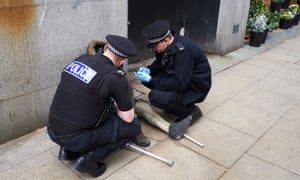 Police in Manchester assist a man who has taken spice