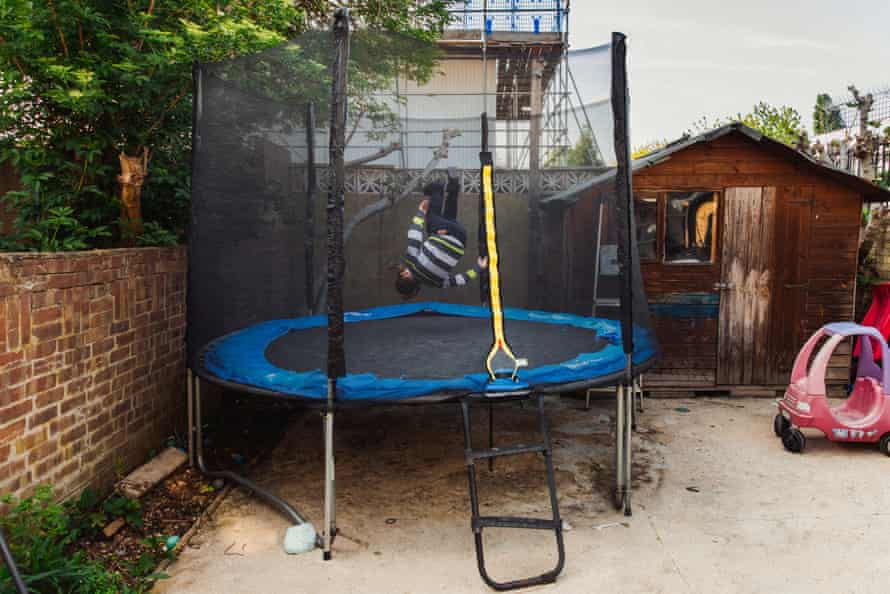 Betzalel turns a somersault on the trampoline in his garden