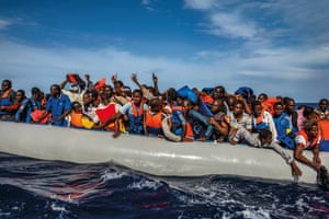 Over 100 African refugees from Gambia, Mali, Senegal, Ivory Coast, Guinea, and Nigeria rescued by the Italian navy from a rubber boat in the sea between Italy and Libya in October 2014