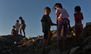 Children playing on a hill of garbage in the Philippines
