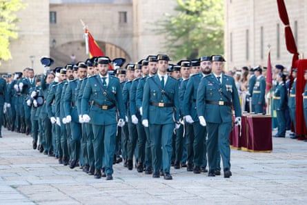 Three ranks of Guardia officers in teal uniforms