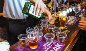 A barman pouring Jagerbombs at the bar at Travellers Friend, (‘The Spivs’), pub, Woodford Green, Essex, England