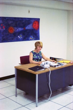 Computer operator Bea poses at her desk