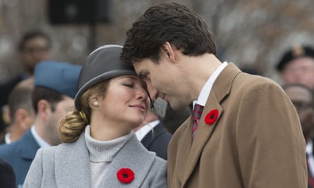 Justin Trudeau and Sophie Gregoire-Trudeau share a moment as they watch Canadian veterans parade past them during Remembrance Day ceremonies in Ottawa on 11 November 2015.