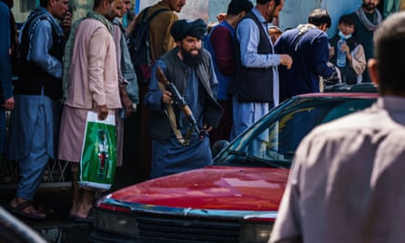 Taliban fighter with AK47 shouting at driver of car