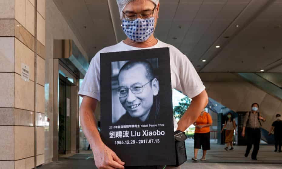 An activist holds a portrait of Chinese dissident and Nobel peace prize recipient Liu Xiaobo after attending a court in Hong Kong for marking the anniversary of the Tiananmen Square massacre. 
