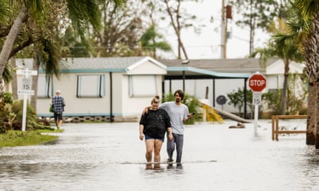 Florida hit by Hurricane Ian<br>epa10214003 People walk through a flooded neighborhood  in the wake of Hurricane Ian in Fort Myers, Florida, USA, 29 September 2022. Hurricane Ian came ashore as a Category 4 hurricane according to the National Hurricane Center and is nearing an exit into the Atlantic Ocean on the East Coast of Florida.  EPA/TANNEN MAURY