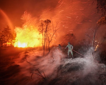 Fire lights up darkness with firefighters battling flames