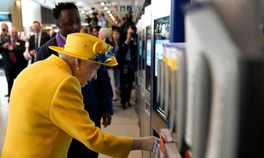 The Queen uses an Oyster card machine during a visit to Paddington station in London
