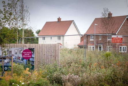 Houses in the distance and a fence in the foreground