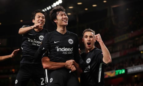 Eintracht Frankfurt’s Daichi Kamada celebrates with teammates after scoring their second goal.