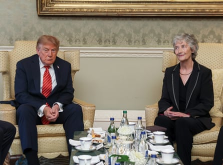 Donald Trump and Catherine Connolly sit in chairs beside a table laden with tea cups and drinks