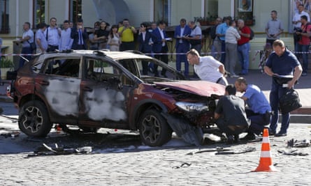 Forensic experts examine the the car in which Pavel Sheremet was killed in a bombing in Ukraine’s capital, Kiev.